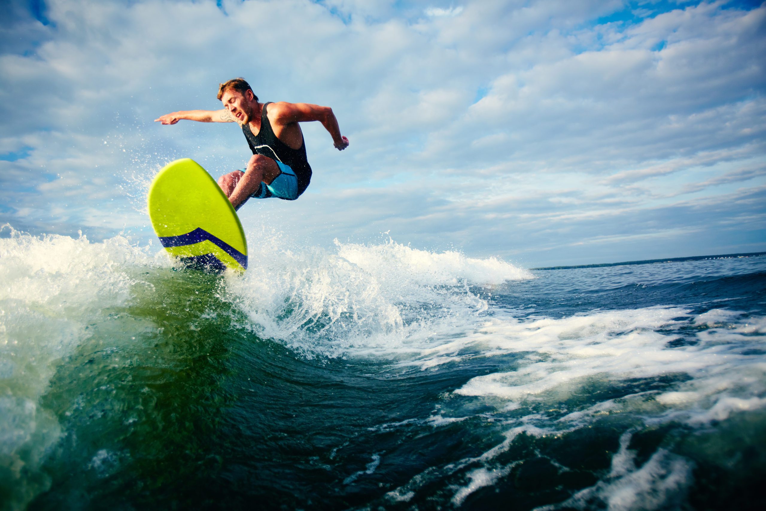 Male surfer riding on waves in the sea